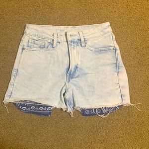 Shorts with patterned pocket showing